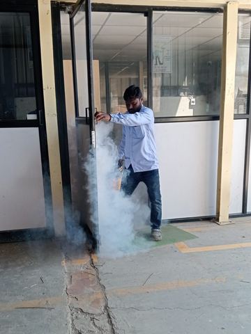 Technician fogging at an office entrance doorway