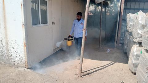 Tezz technician fogging the outside perimeter of a site office building