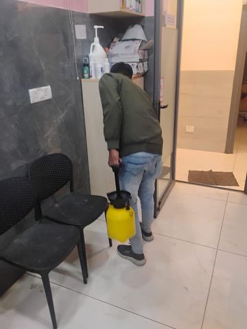Tezz technician treating the base of a doorway and seating area during a commercial visit