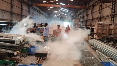 Technician fogging a working warehouse floor in the Pune region